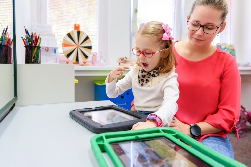 AAC for nonverbal children: child using a communication tablet with therapist support