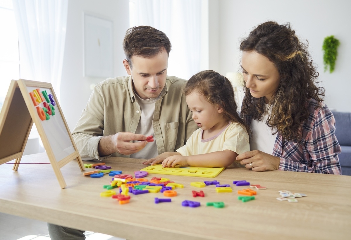 Parents supporting child's development while exploring OPWDD autism services