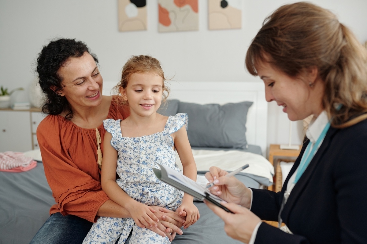Care coordinator reviewing paperwork with a family for OPWDD services in the Bronx